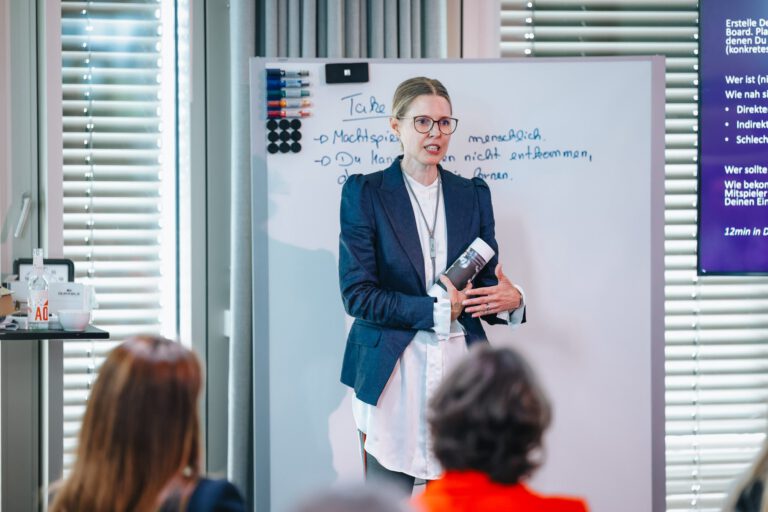 Sandra Cameron speaking to an audience during a leadership event.