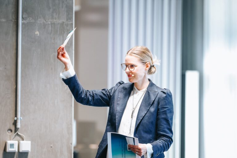 Sandra Cameron facilitating a leadership workshop in front of a whiteboard.